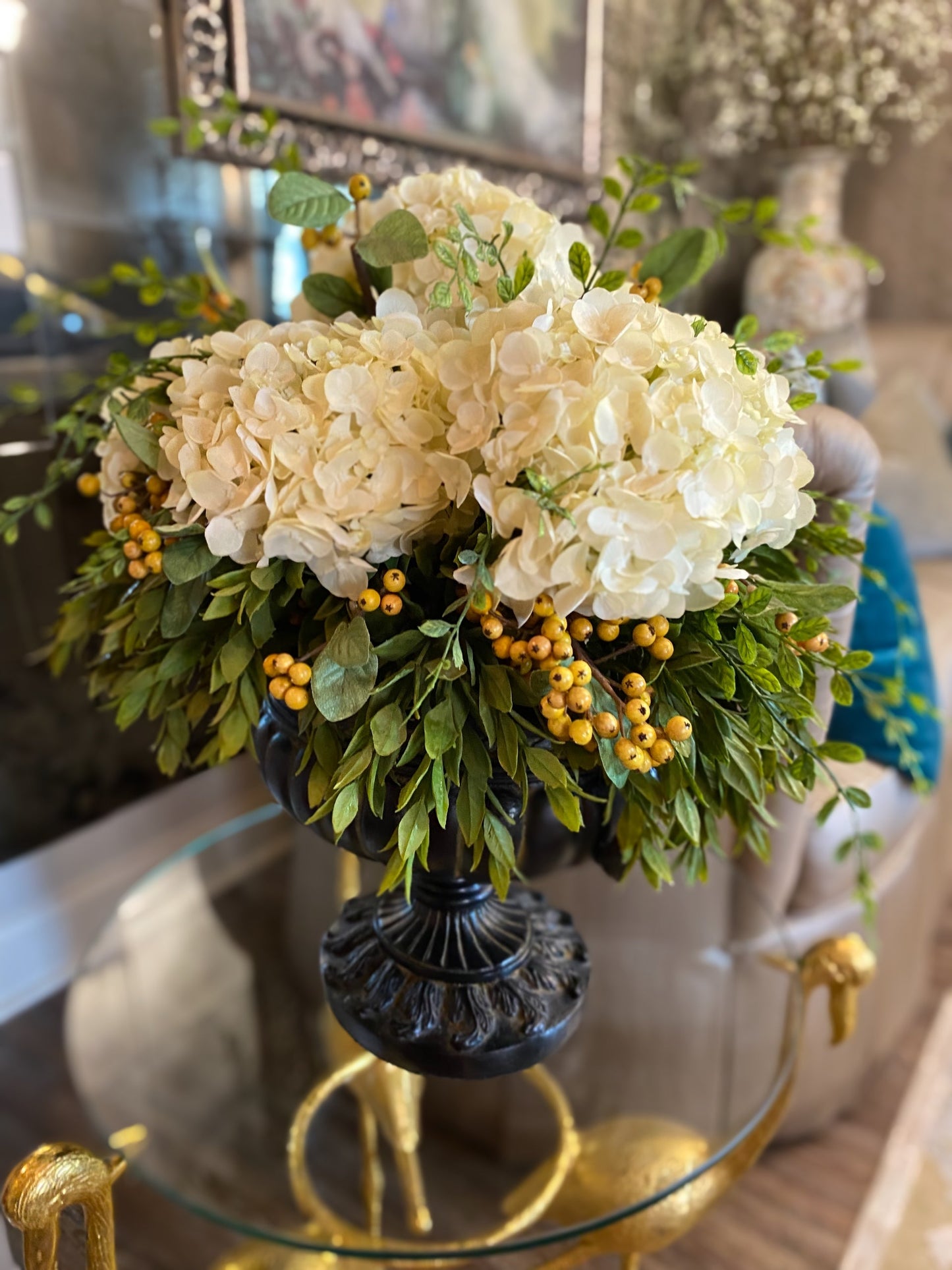 Hydrangeas draping greenery berries distress roman vase arrangement