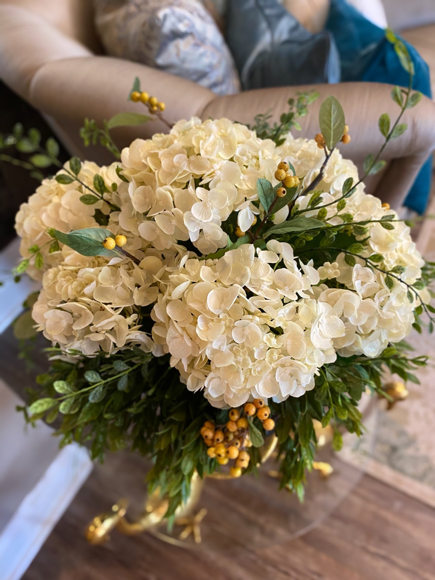 Hydrangeas draping greenery berries distress roman vase arrangement